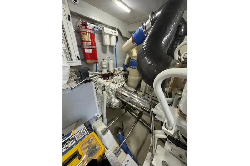 Slide: The Image of Engine room of 2008 Marquis 65 Skylounge yacht with visible machinery and fire extinguisher. - 81