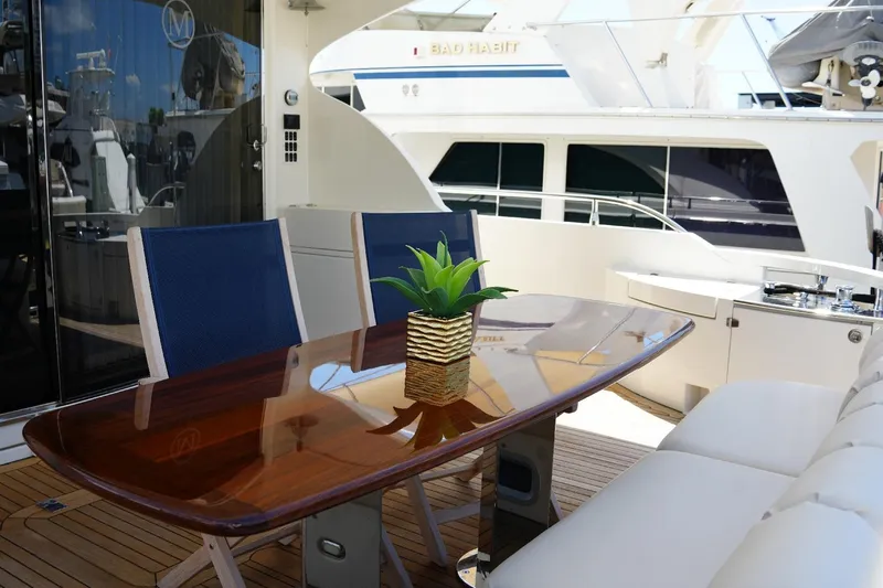 Slide: The Image of Luxurious 2008 Marquis 65 Skylounge yacht deck with elegant dining area and potted plant. - 22