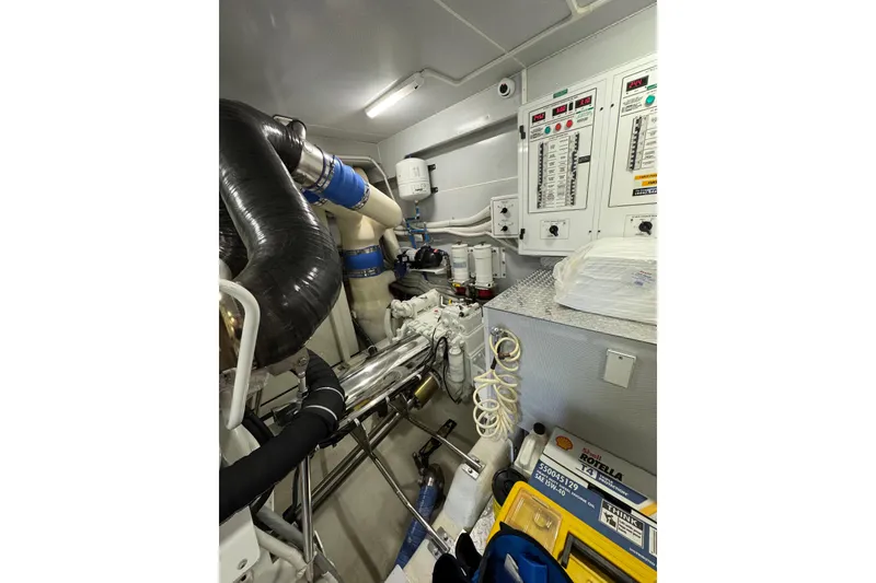 Slide: The Image of Engine room of 2008 Marquis 65 Skylounge yacht with control panels and machinery. - 80