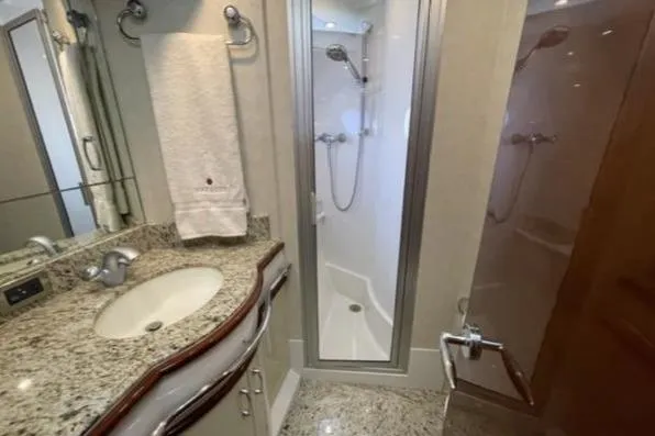 Slide: The Image of Luxurious bathroom in 2008 Marquis 65 Skylounge yacht with granite countertop and enclosed shower. - 66
