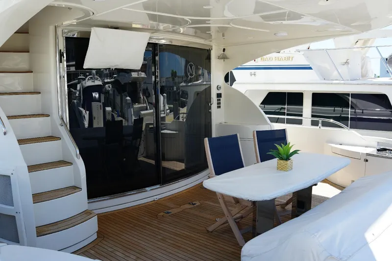 Slide: The Image of Luxurious 2008 Marquis 65 Skylounge yacht deck with seating and table. - 19