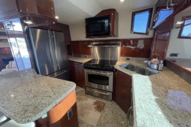 Slide: The Image of Luxurious kitchen interior of 2008 Marquis 65 Skylounge yacht with granite countertops and stainless steel appliances. - 43