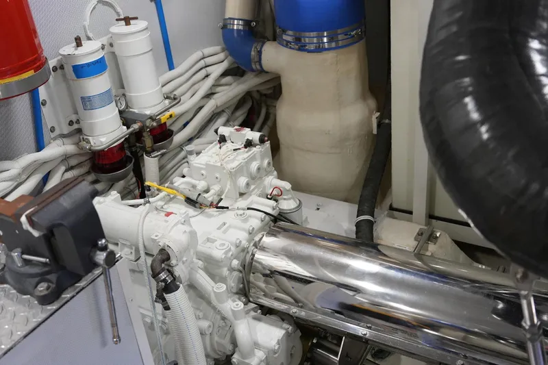Slide: The Image of Engine room of 2008 Marquis 65 Skylounge yacht, showcasing mechanical components and piping. - 72