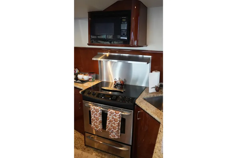 Slide: The Image of Luxurious kitchen in 2008 Marquis 65 Skylounge yacht with modern appliances. - 46