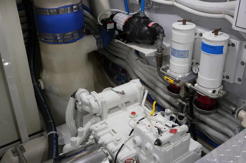 Slide: The Image of Engine room of 2008 Marquis 65 Skylounge yacht, showcasing mechanical components and piping. - 74