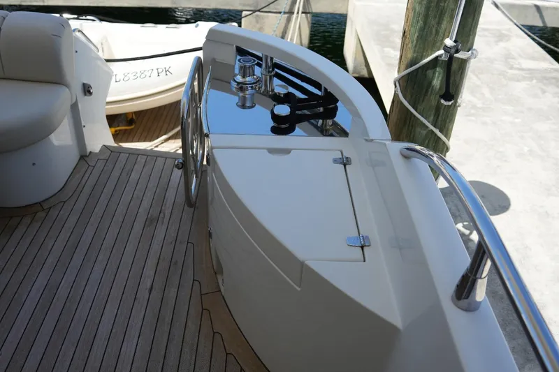 Slide: The Image of 2008 Marquis 65 Skylounge yacht deck with polished metal fittings and wooden flooring. - 4
