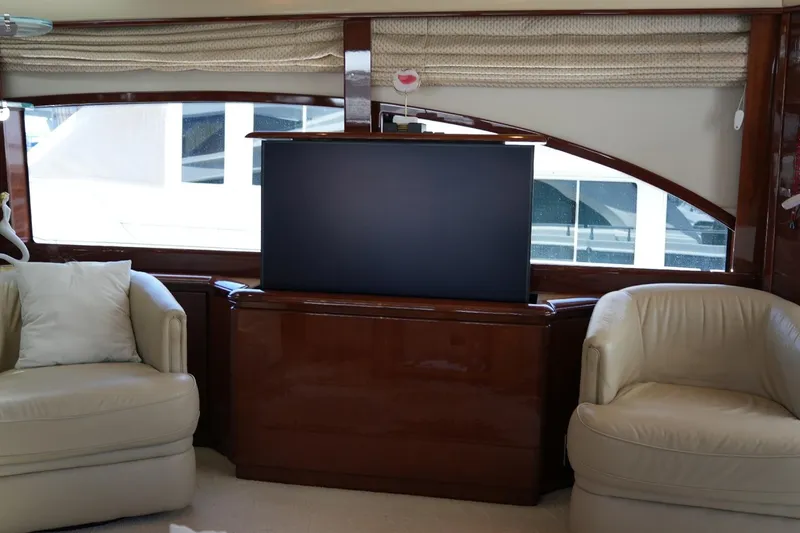Slide: The Image of Luxurious interior of 2008 Marquis 65 Skylounge yacht with plush seating and TV. - 16