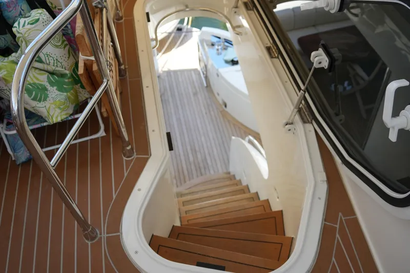Slide: The Image of Staircase on 2008 Marquis 65 Skylounge yacht with teak flooring and stainless steel railings. - 39