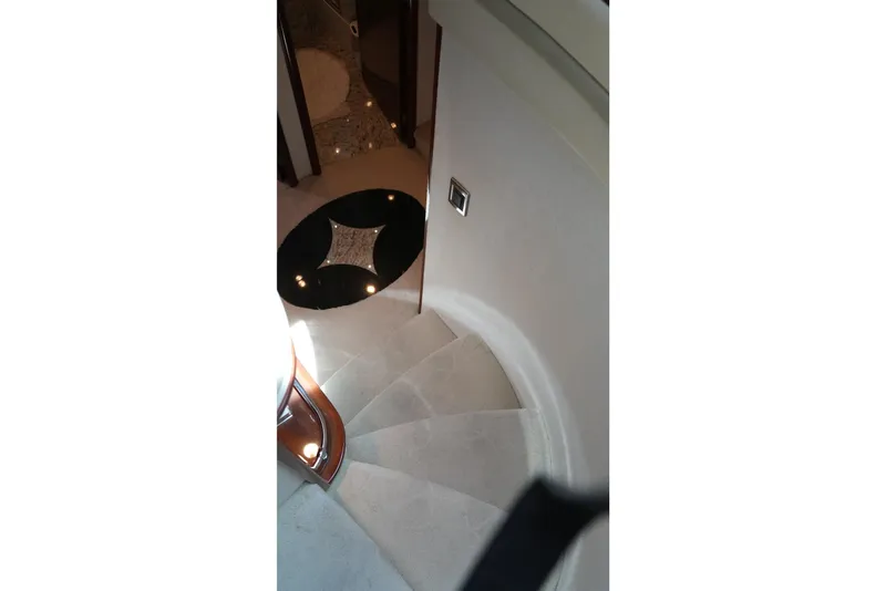 Slide: The Image of Curved staircase inside 2008 Marquis 65 Skylounge yacht, featuring elegant design and lighting. - 51