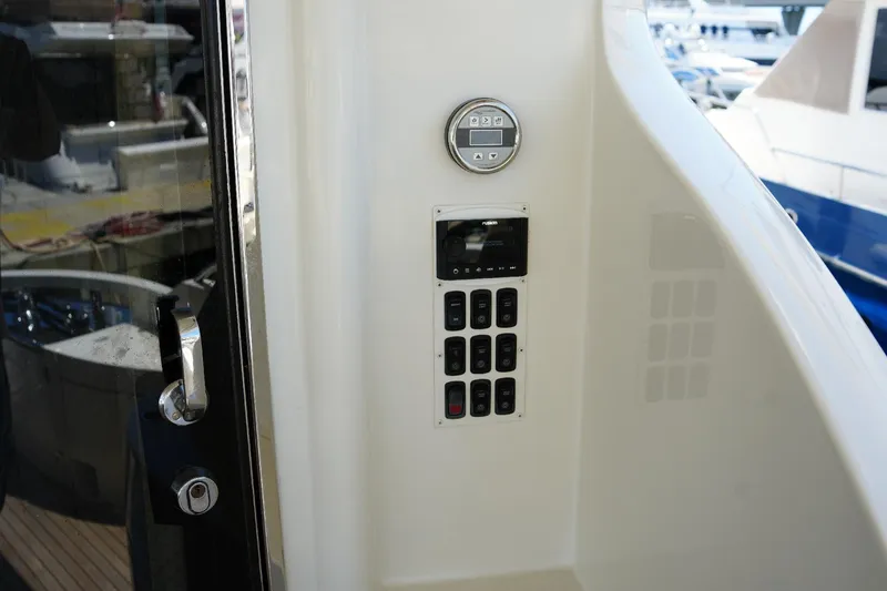 Slide: The Image of Control panel on a 2008 Marquis 65 Skylounge yacht, featuring buttons and a display. - 23