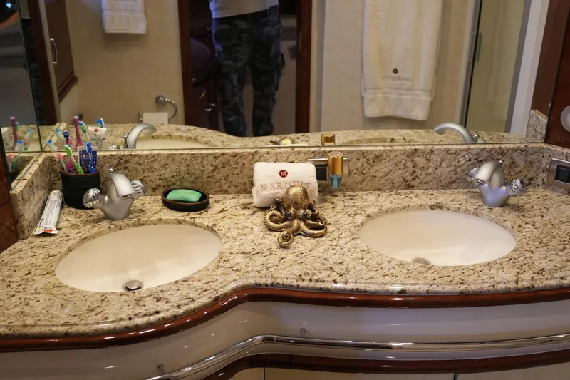 Slide: The Image of Luxurious bathroom vanity in 2008 Marquis 65 Skylounge yacht with dual sinks and granite countertop. - 65