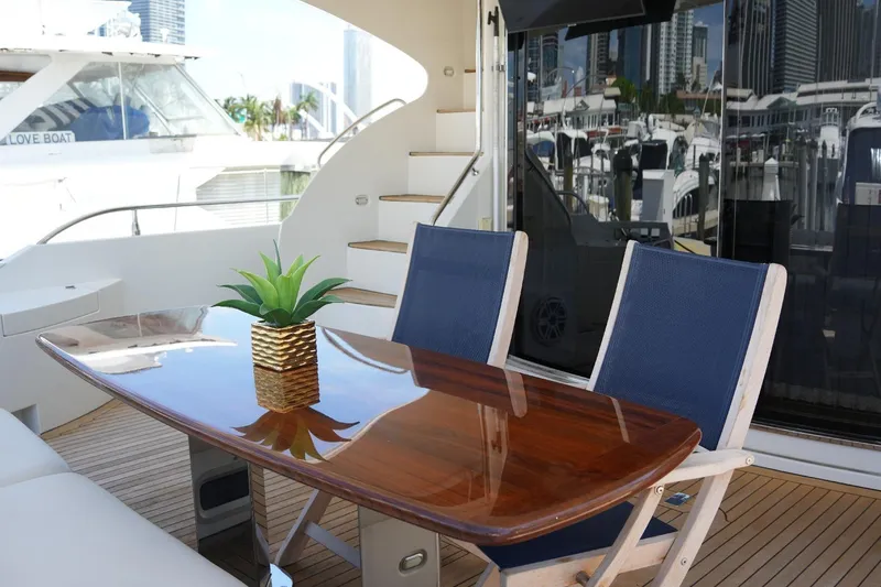 Slide: The Image of Luxurious 2008 Marquis 65 Skylounge yacht deck with elegant seating and table. - 26