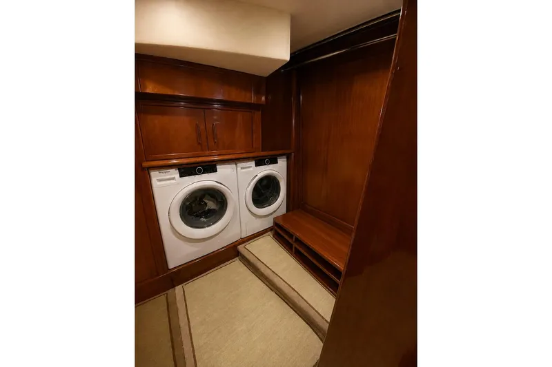 Slide: The Image of Laundry area in 2008 Marquis 65 Skylounge yacht with wood cabinetry and Whirlpool appliances. - 60