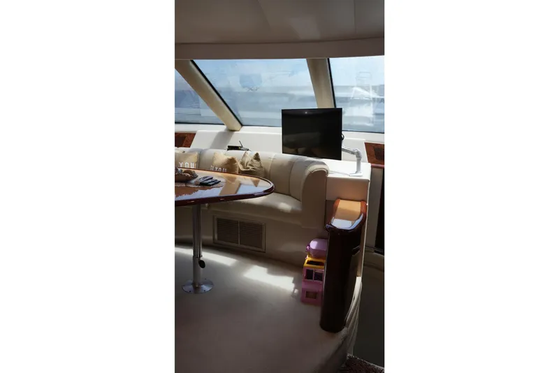 Slide: The Image of Luxurious interior of a 2008 Marquis 65 Skylounge yacht with plush seating and a TV. - 48