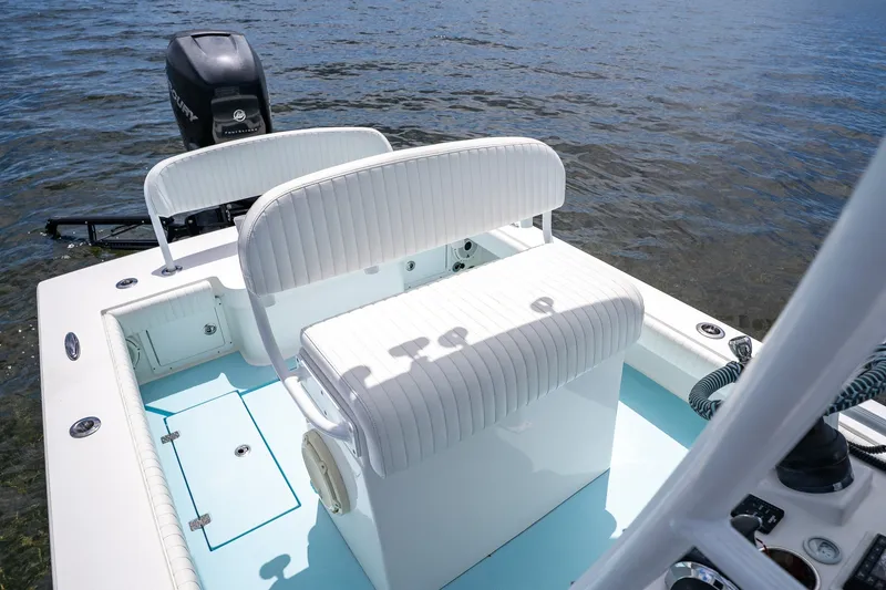 Slide: The Image of 2018 Dorado 25 SE boat interior with white seating and Mercury outboard motor. - 34