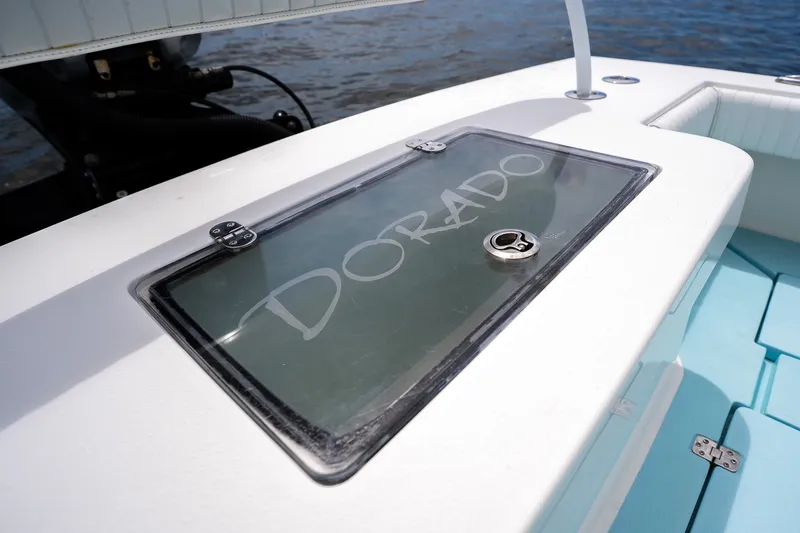 Slide: The Image of 2018 Dorado 25 SE boat deck with branded storage compartment. - 70