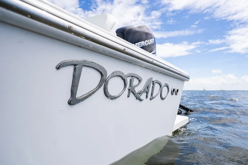 Slide: The Image of 2018 Dorado 25 SE boat on water with clear sky background. - 76