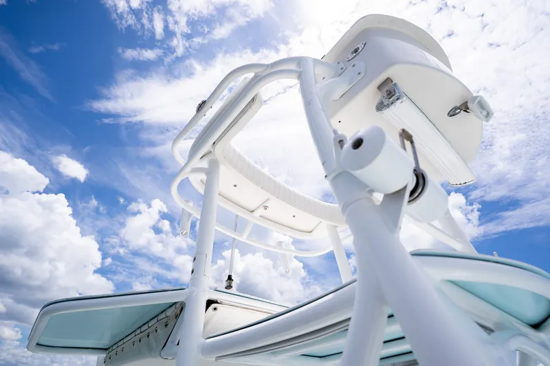 Slide: The Image of 2018 Dorado 25 SE boat tower against a vibrant blue sky with clouds. - 45