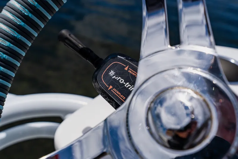 Slide: The Image of Close-up of a 2018 Dorado 25 SE boat steering wheel and control lever. - 48