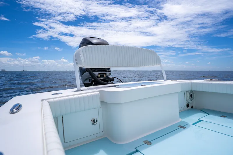 Slide: The Image of 2018 Dorado 25 SE boat on open water under a clear blue sky. - 69