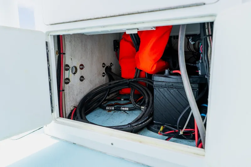 Slide: The Image of Storage compartment of 2018 Dorado 25 SE boat with cables and life jacket. - 38