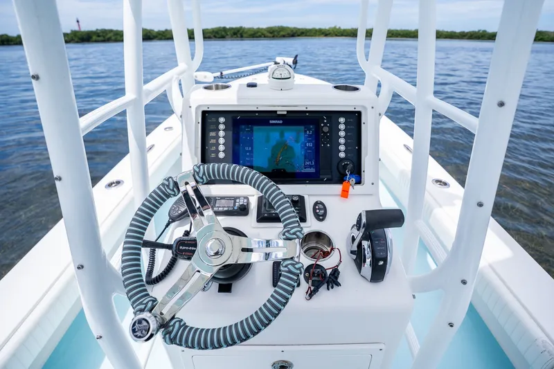 Slide: The Image of 2018 Dorado 25 SE boat dashboard with steering wheel and navigation system. - 32