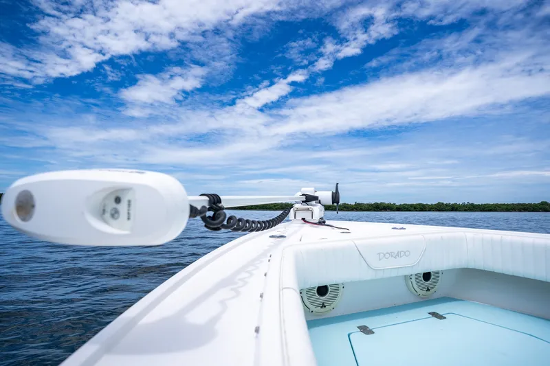 Slide: The Image of 2018 Dorado 25 SE boat on water under blue sky with clouds. - 25