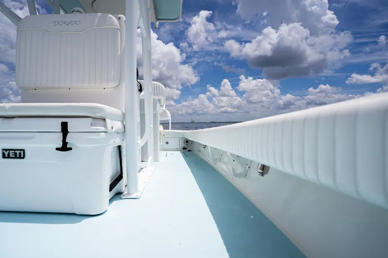Slide: The Image of 2018 Dorado 25 SE boat deck with Yeti cooler under a cloudy sky. - 43