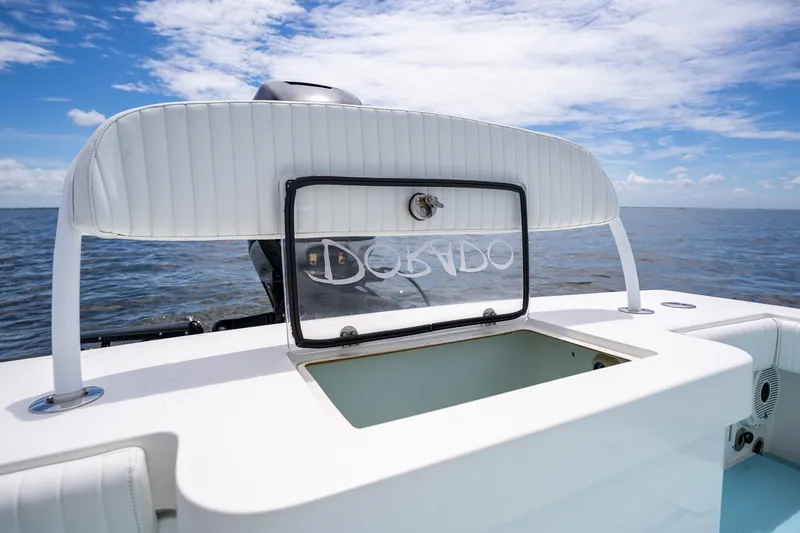 Slide: The Image of 2018 Dorado 25 SE boat with open storage, ocean view, and clear sky. - 71