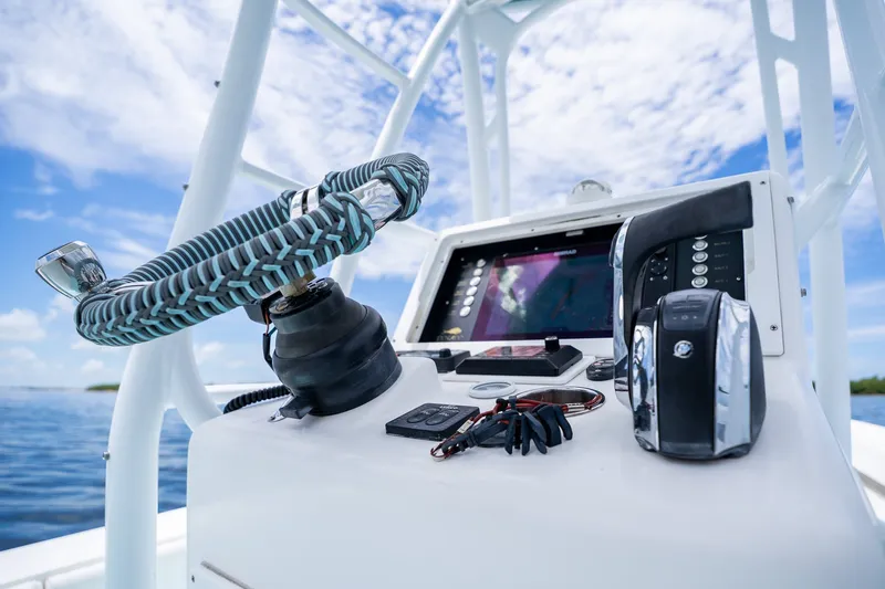 Slide: The Image of 2018 Dorado 25 SE boat dashboard with steering wheel and navigation controls. - 39
