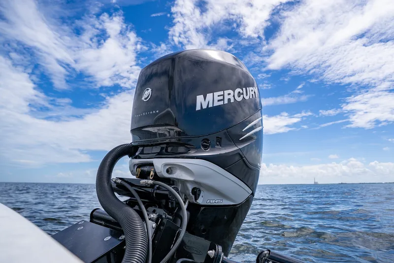 Slide: The Image of Mercury outboard motor on 2018 Dorado 25 SE boat, ocean backdrop, blue sky. - 73