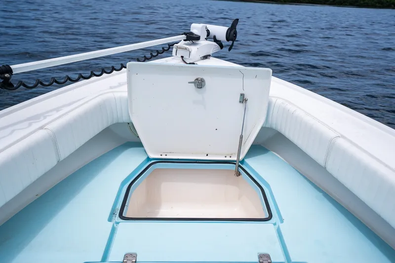 Slide: The Image of 2018 Dorado 25 SE boat with open storage compartment on calm water. - 20