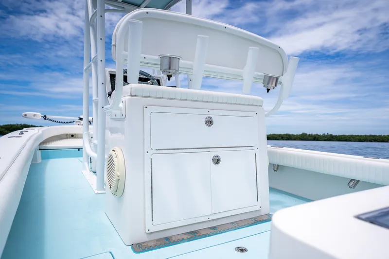 Slide: The Image of 2018 Dorado 25 SE boat interior with storage compartments, under a clear blue sky. - 53