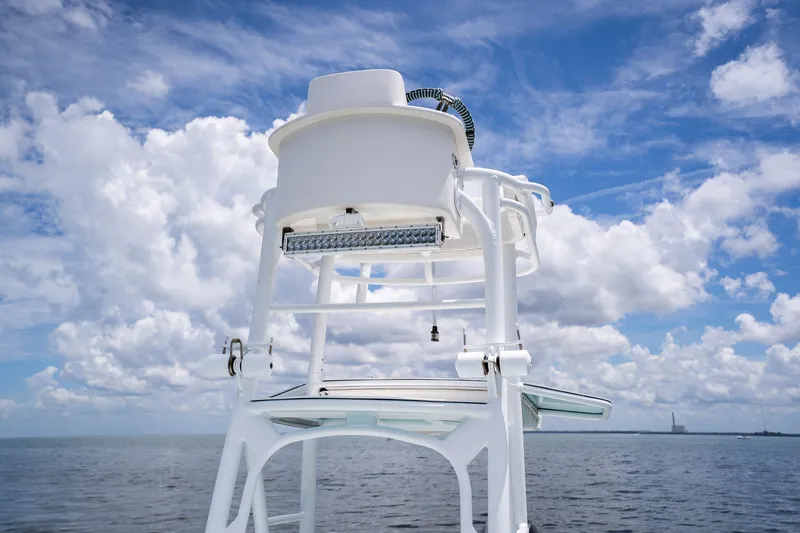 Slide: The Image of 2018 Dorado 25 SE boat tower against a cloudy sky and ocean backdrop. - 50