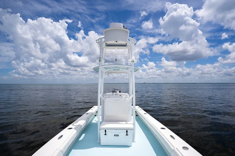 Slide: The Image of 2018 Dorado 25 SE boat on open water under a cloudy sky. - 27