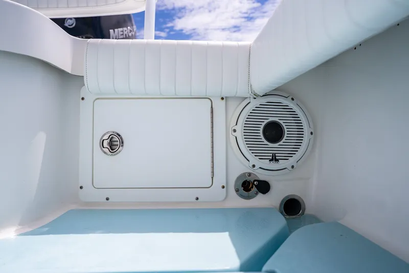 Slide: The Image of Interior of 2018 Dorado 25 SE boat featuring speaker and storage compartment. - 60