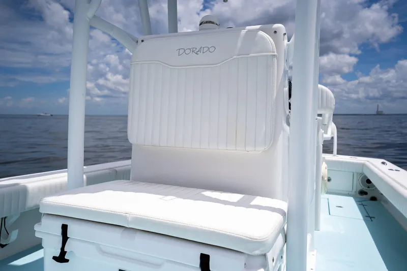 Slide: The Image of 2018 Dorado 25 SE boat interior with white seating, ocean view, and blue sky. - 29