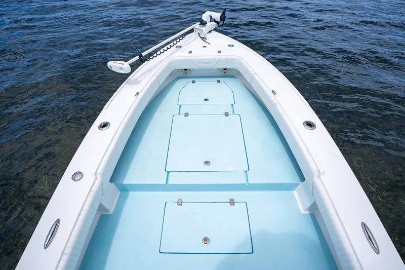 Slide: The Image of 2018 Dorado 25 SE boat deck with storage compartments on calm water. - 16