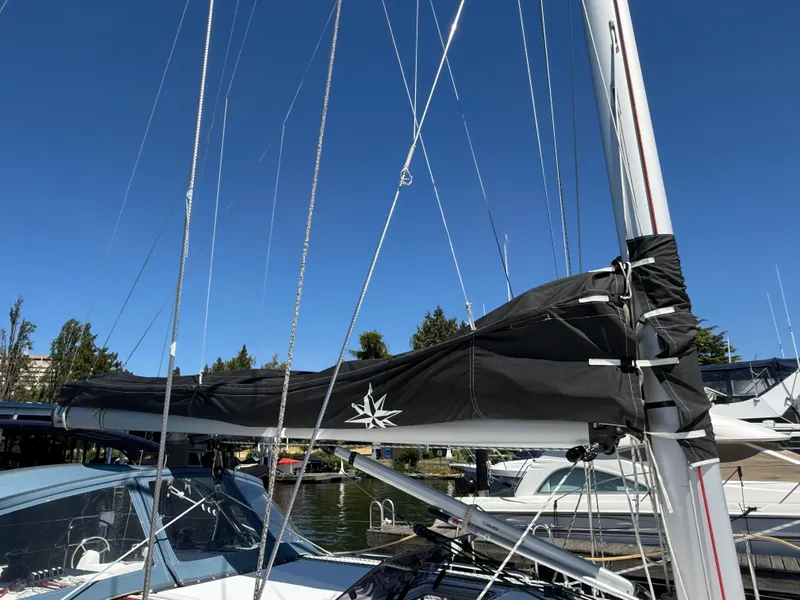 Slide: The Image of 2021 Jeanneau Sun Odyssey 410 sailboat mast and boom under clear blue sky. - 24
