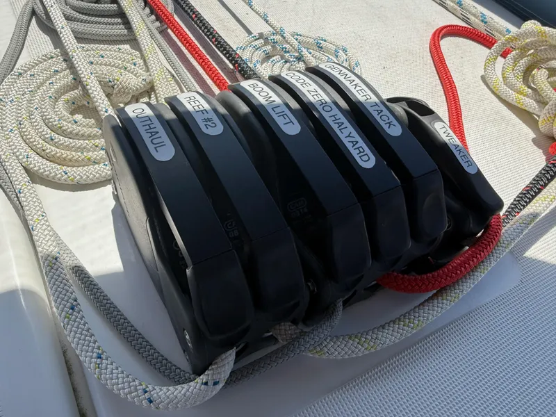 Slide: The Image of Rope clutches on Jeanneau Sun Odyssey 410 sailboat, labeled for various sailing functions. - 23