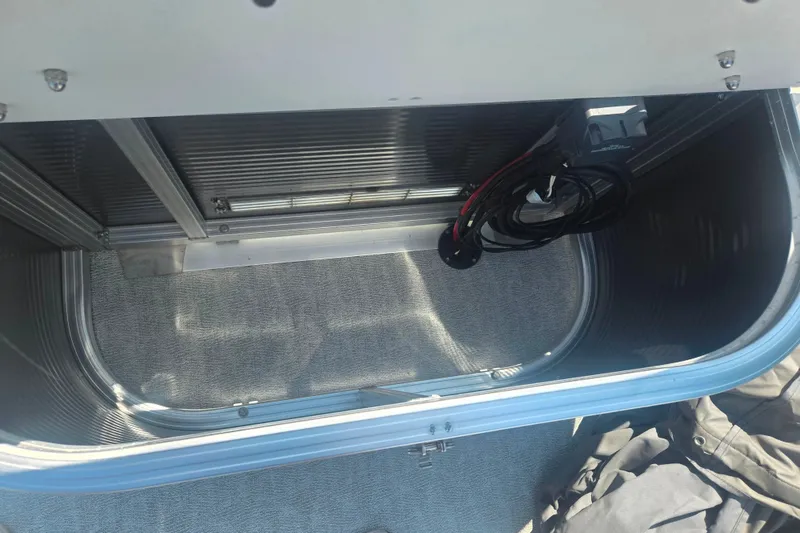 Slide: The Image of Open storage compartment in 2020 Avalon LSZ Cruise Rear Bench boat. - 18