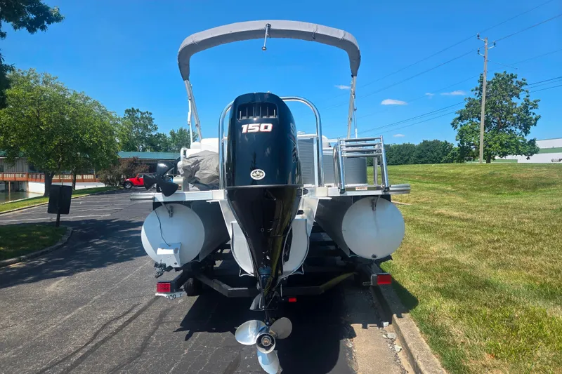 Slide: The Image of 2020 Avalon LSZ Cruise Rear Bench pontoon boat with 150 HP engine on trailer. - 2
