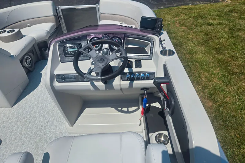 Slide: The Image of 2020 Avalon LSZ Cruise Rear Bench boat dashboard with steering wheel and controls. - 24