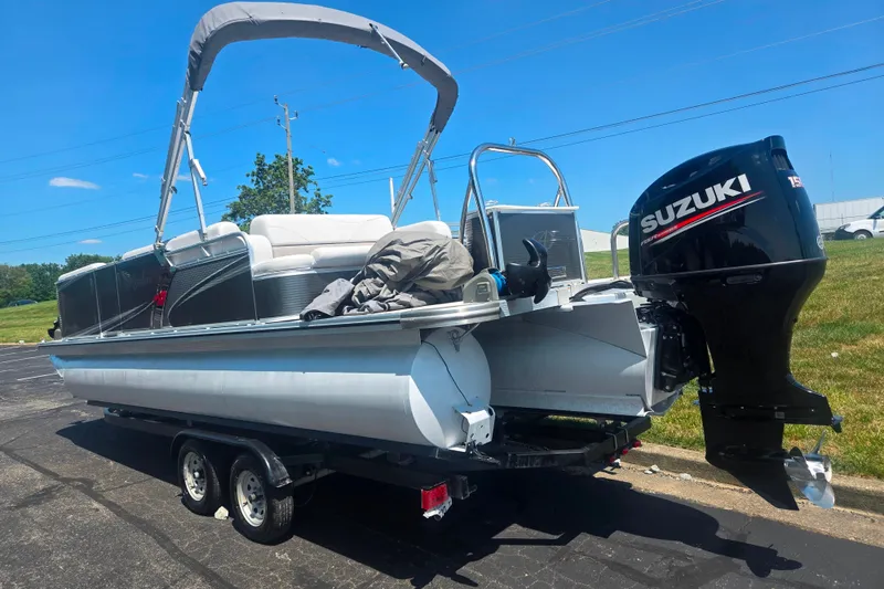 Slide: The Image of 2020 Avalon LSZ Cruise Rear Bench pontoon boat with Suzuki outboard motor on trailer. - 3