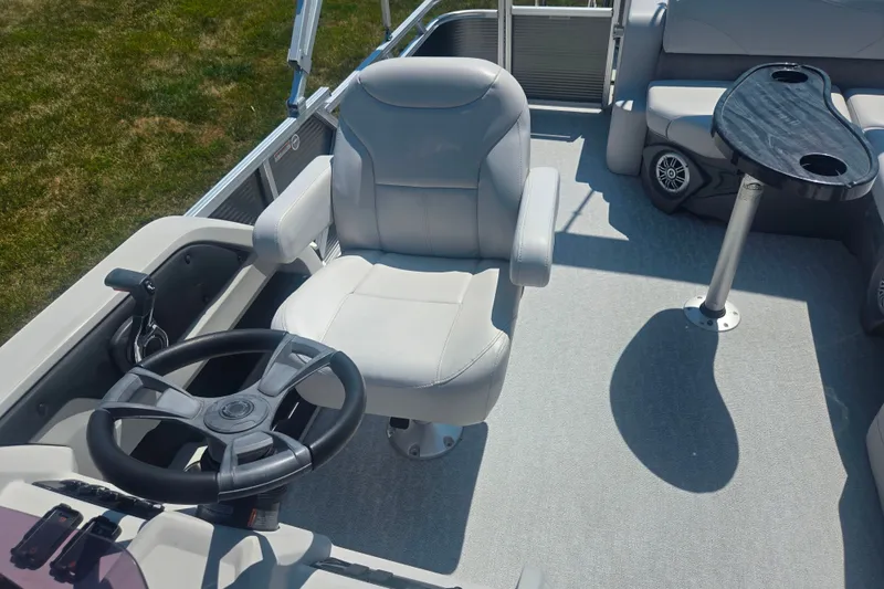 Slide: The Image of 2020 Avalon LSZ Cruise Rear Bench boat interior with steering wheel and seating area. - 13