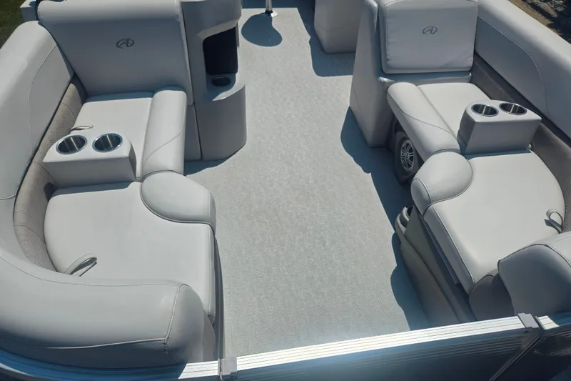 Slide: The Image of 2020 Avalon LSZ Cruise Rear Bench boat interior with plush seating and cup holders. - 10