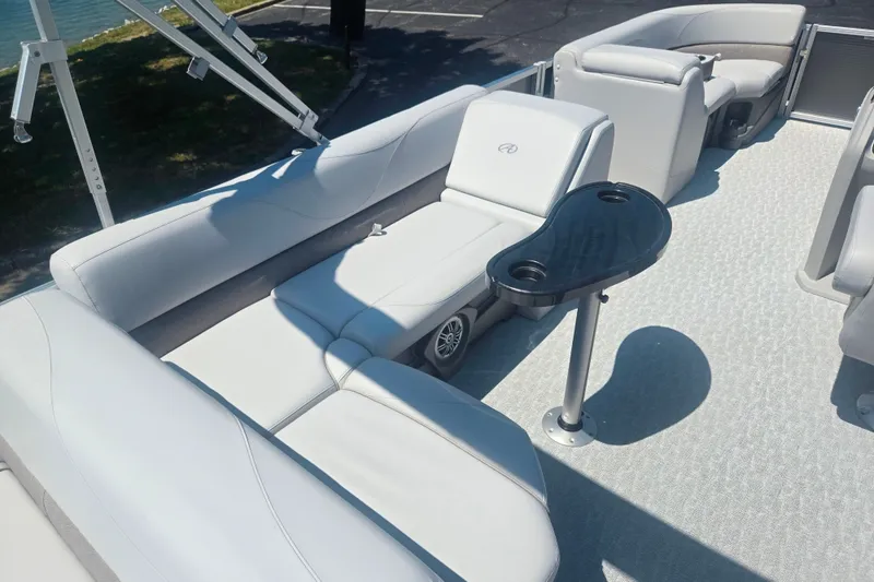 Slide: The Image of 2020 Avalon LSZ Cruise Rear Bench boat interior with plush seating and cup holder table. - 22