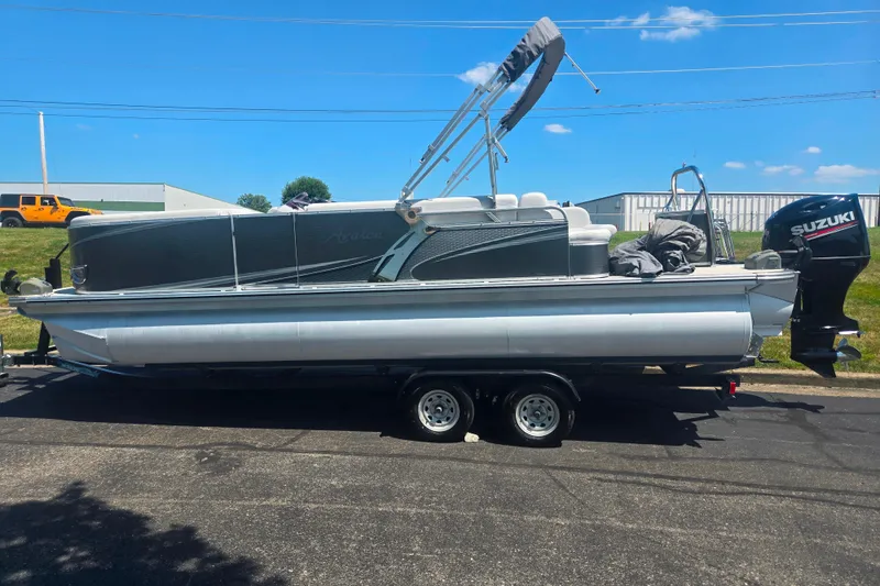 Slide: The Image of 2020 Avalon LSZ Cruise Rear Bench pontoon boat on trailer, featuring Suzuki outboard motor. - 4