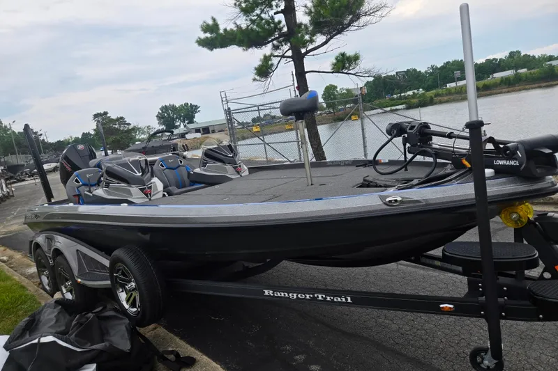 Slide: The Image of 2023 Ranger Z521R boat on trailer by waterfront, featuring sleek design and modern equipment. - 9
