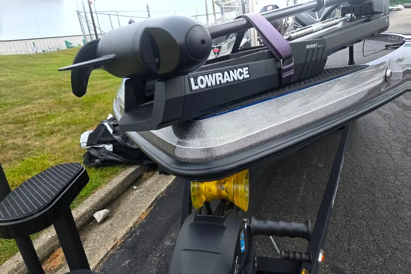 Slide: The Image of 2023 Ranger Z521R boat with Lowrance equipment, parked on pavement near grass. - 7
